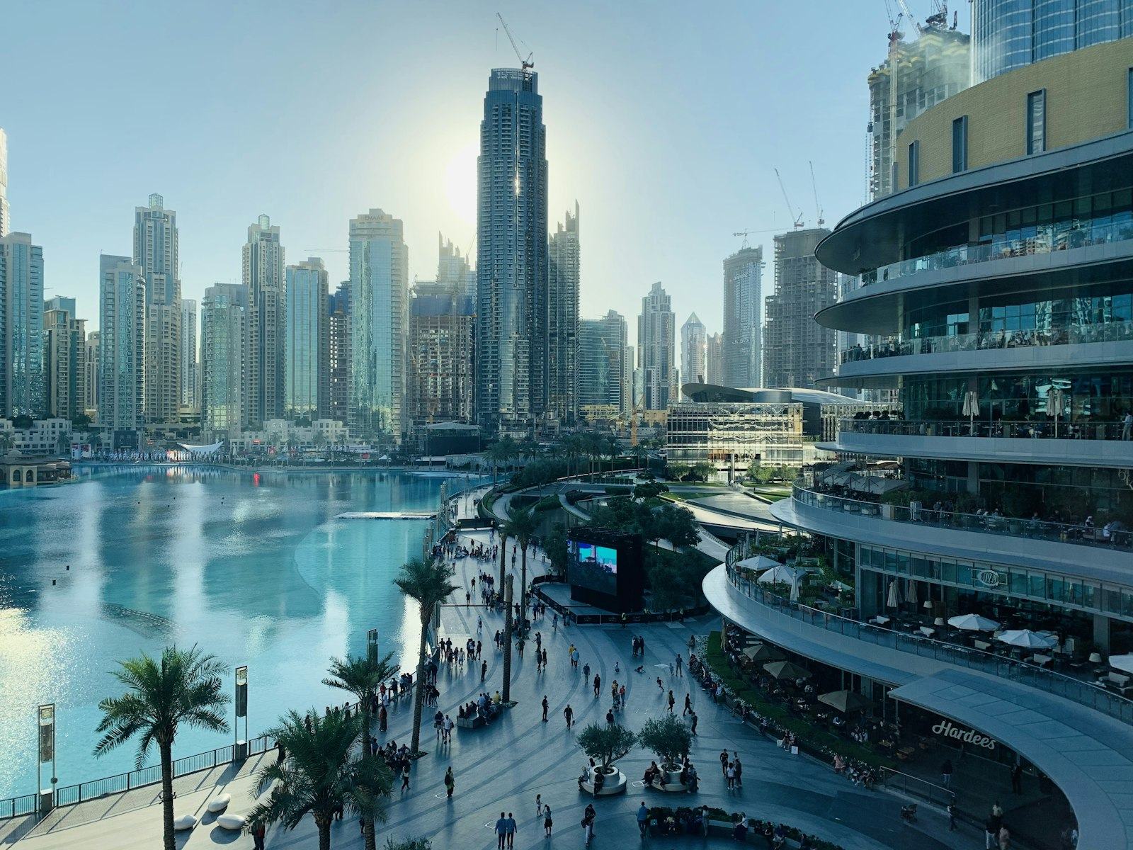 People walking along a Dubai waterfront promenade