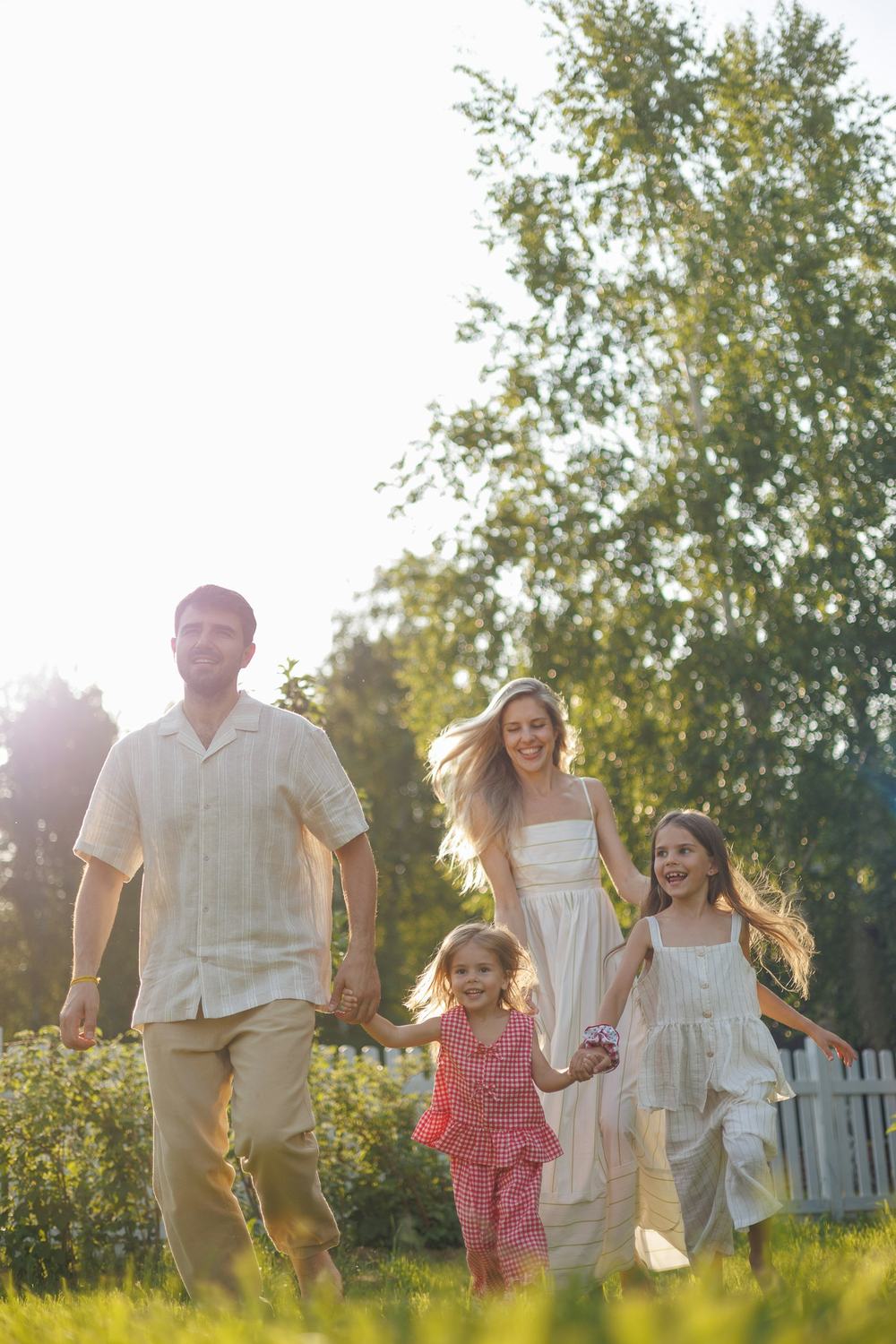 A family running together in a sunny garden